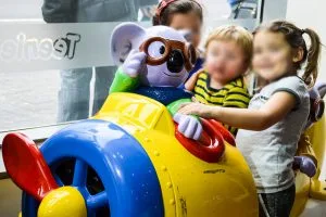 Kids playing on a Teenie Weenies airplane ride